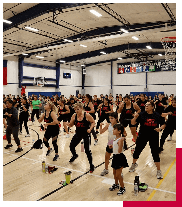 A large group exercising in a gymnasium.
